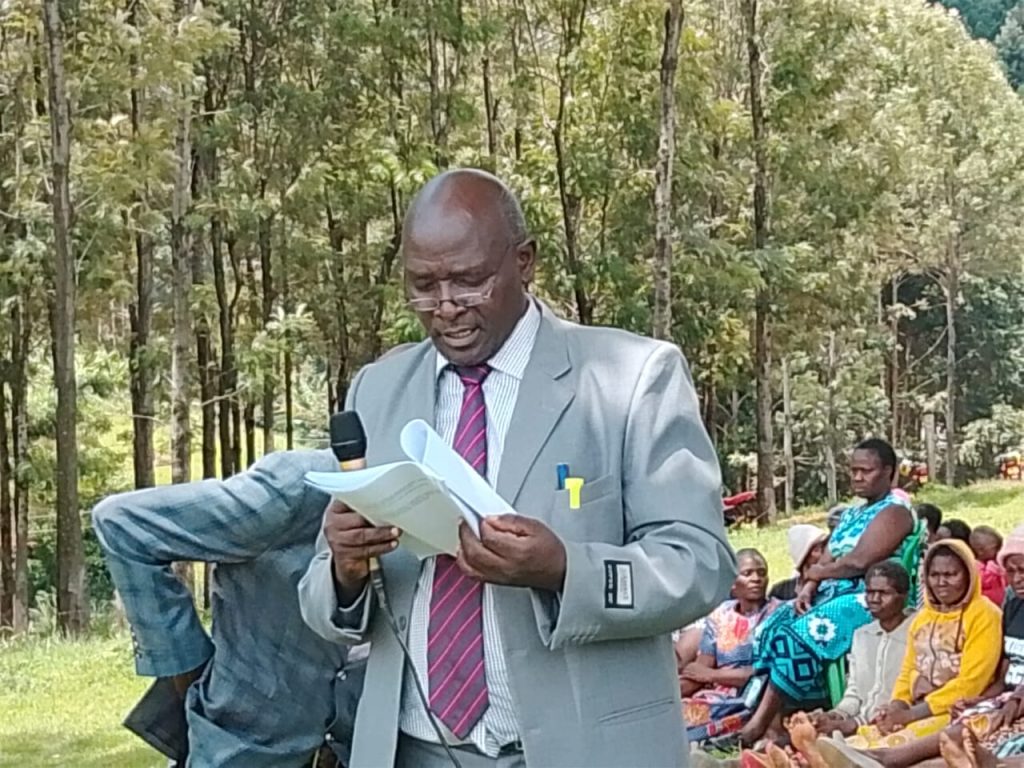 Philip Achiki reading a petition to the Senate Committee