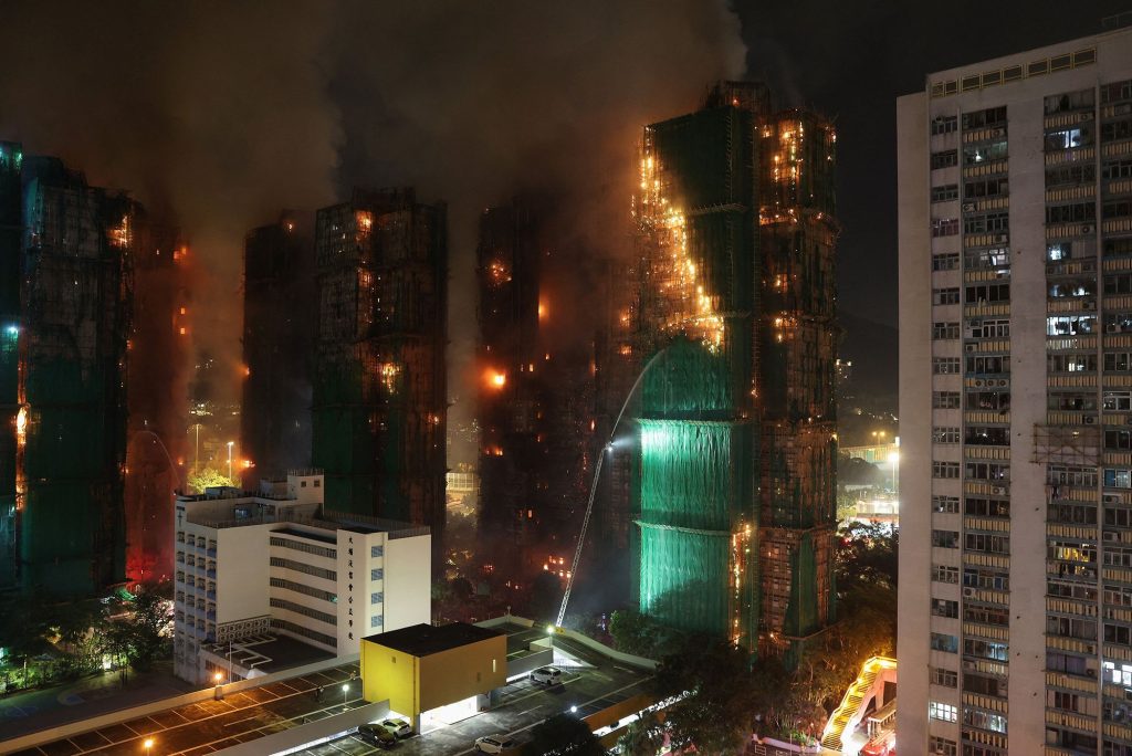 At least 13 dead as fire engulfs Hong Kong tower blocks