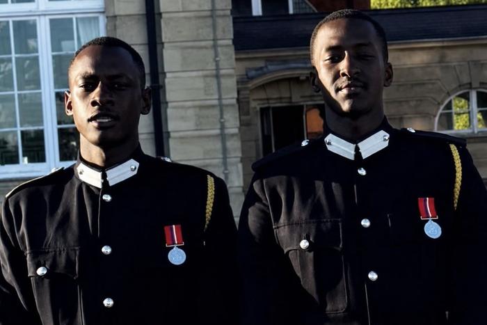 Ruhamya Kainerugaba Graduates from Royal Military Academy Sandhurst Ruhamya Kainerugaba, son of Uganda's Chief of Defence Forces General Muhoozi Kainerugaba, has graduated from the Royal Military Academy Sandhurst in England. He completed the academy's Officer Cadet Course and graduated on August 5, 2026. Ruhamya graduated alongside fellow Ugandan Officer Cadet Bakira Ruyondo. The two were among hundreds of officer cadets who passed out during a graduation parade held at the academy's historic campus in Camberley, Surrey. Ruhamya serves in the Uganda Peoples' Defence Forces (UPDF) with the rank of Private. Family Tradition Ruhamya's graduation follows the path taken by his father nearly three decades earlier. General Muhoozi Kainerugaba joined the UPDF as an Officer Cadet in 1999 and graduated from Sandhurst in 2000, where he was commissioned as a Second Lieutenant. The academy is the British Army's premier officer training institution and is widely regarded as one of the most respected military training institutions in the world. It trains officers for the British Army and armed forces from other countries, with a history dating back to the establishment of the Royal Military College in 1801. Ruhamya is among a growing number of sons of East African leaders to train at the academy, including Lt. Ian Kagame, son of Rwanda's President Paul Kagame, who graduated as a Second Lieutenant in 2022. Reactions Local Government Minister Balaam Barugahara congratulated Ruhamya and Ruyondo in a post on X, writing: "Congratulations to our own young men who have made it at the prestigious military academy pass-out"