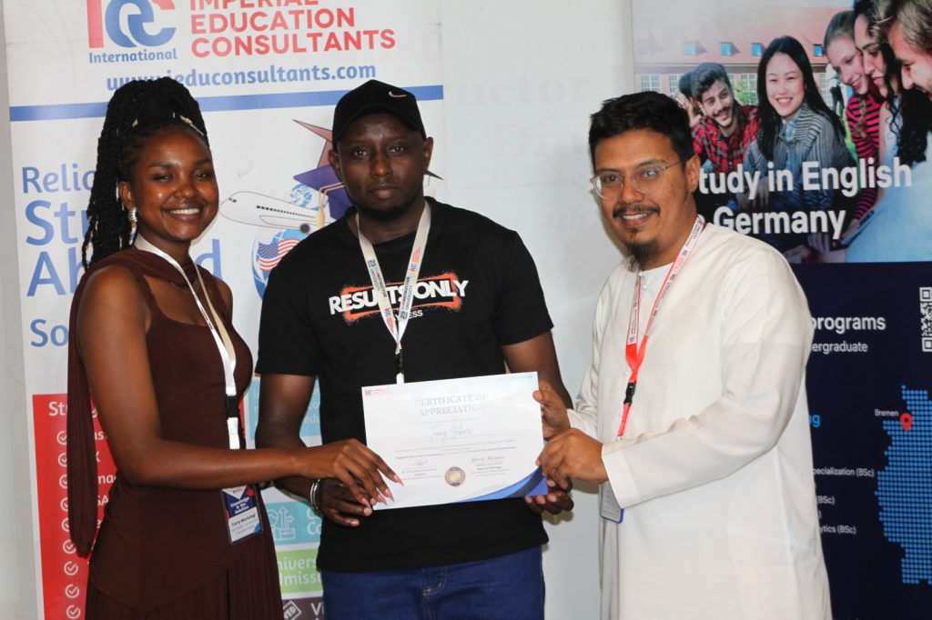 Constructor Regional Representative Terry Muirungi and Imperial Education Consultants Director Mohammed Kamara presenting a certificate to a participant yesterday